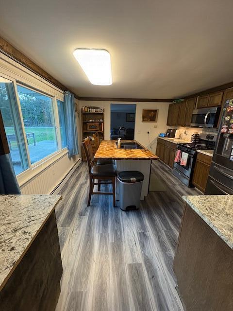 dining area with baseboard heating and dark wood-type flooring
