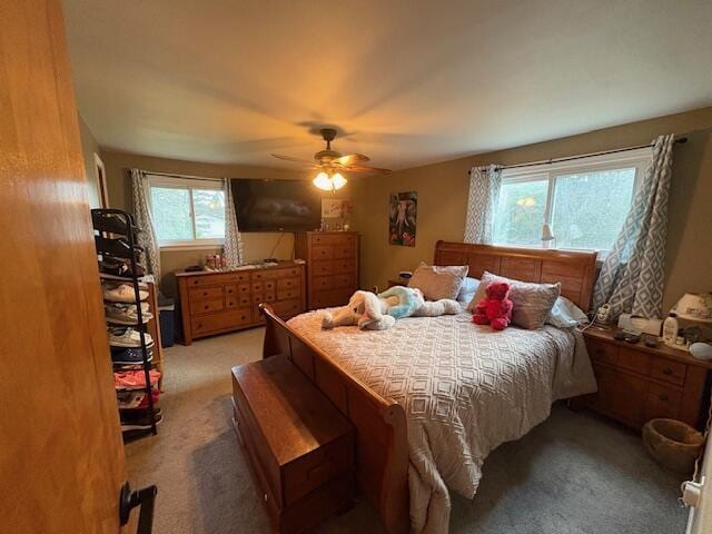 bedroom featuring light carpet and a ceiling fan