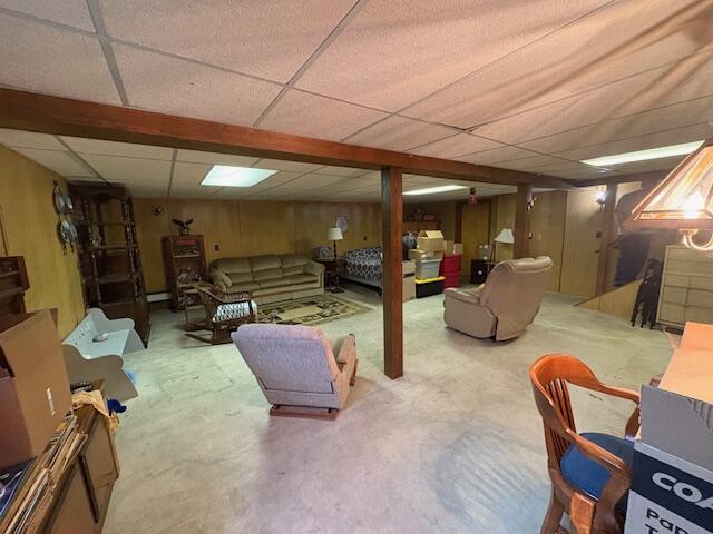 finished below grade area featuring a paneled ceiling