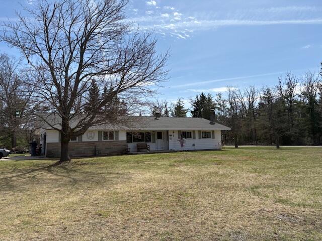 single story home featuring an attached garage and a front lawn