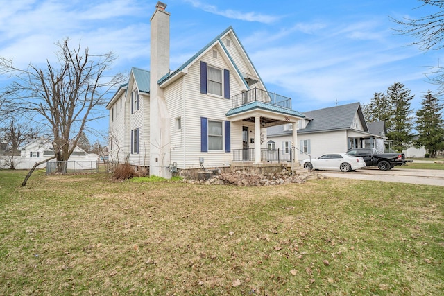 334 E Main St, Gaylord, MI 49735 - view of front of property featuring a balcony, a chimney, a porch, and metal roof
