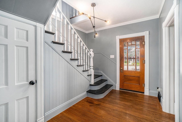 334 E Main St, Gaylord, MI 49735 - entrance foyer with a chandelier, stairs, wood finished floors, ornamental molding, and baseboards