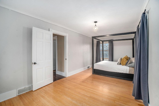 334 E Main St, Gaylord, MI 49735 - bedroom with baseboards, wood finished floors, and crown molding