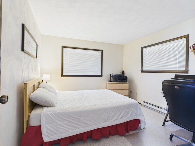 carpeted bedroom featuring a baseboard heating unit