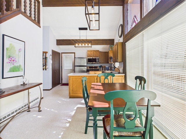 dining area with vaulted ceiling with beams and baseboard heating