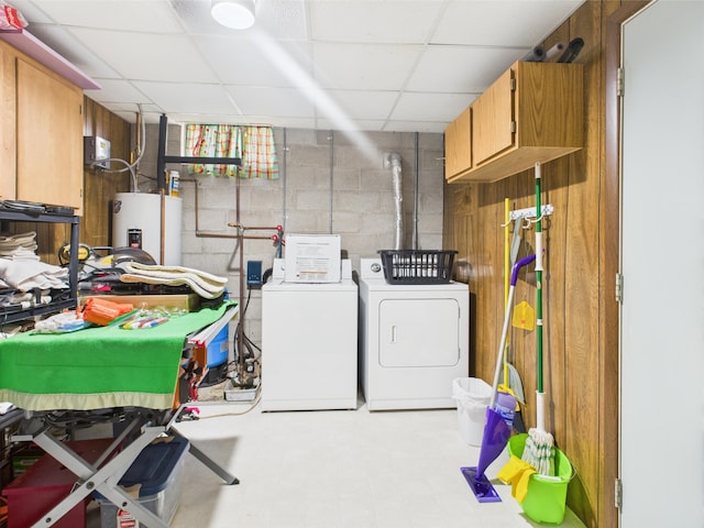 washroom with tile patterned floors, separate washer and dryer, cabinet space, water heater, and concrete block wall