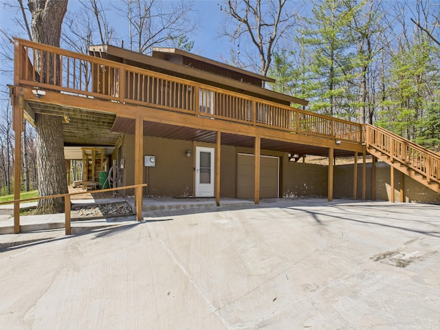 exterior space featuring a wooden deck, stairs, and a garage
