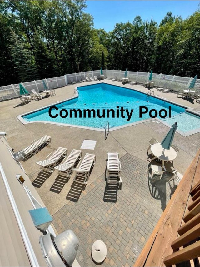 pool featuring a patio area and fence
