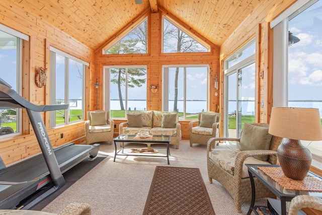 sunroom featuring a water view, wood walls, wooden ceiling, and vaulted ceiling with beams