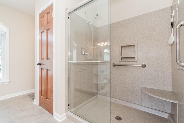 full bath with baseboards and a shower stall