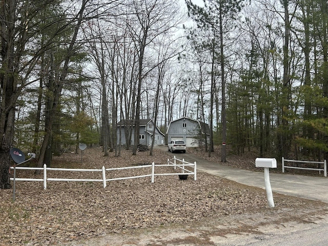 view of front of home featuring a detached garage and fence