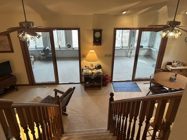 interior space with carpet floors, ceiling fan, and a wealth of natural light