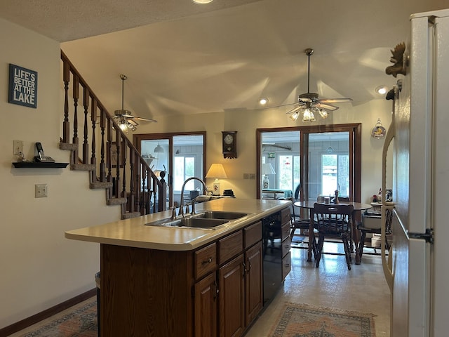 kitchen with ceiling fan, a sink, light countertops, black dishwasher, and freestanding refrigerator