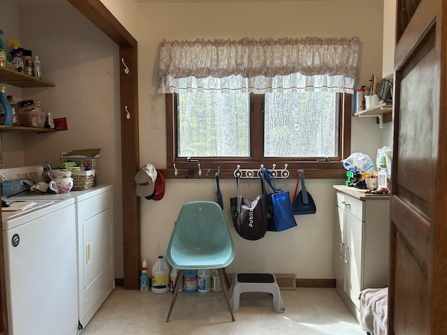 clothes washing area featuring laundry area, washer and clothes dryer, and baseboards