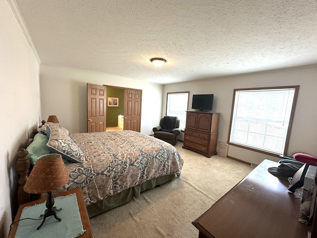bedroom featuring a textured ceiling and light carpet