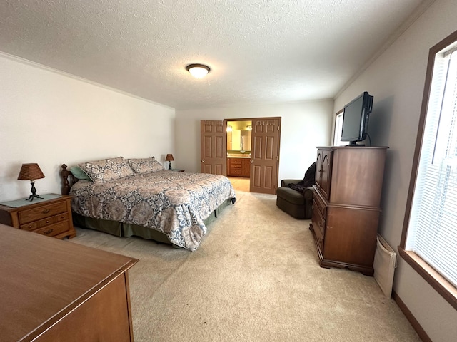 bedroom with a textured ceiling and light colored carpet