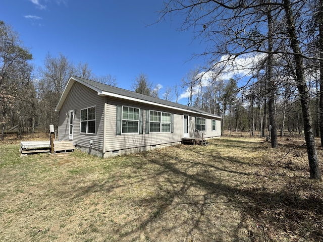 view of front of home featuring a front yard, a deck, and crawl space