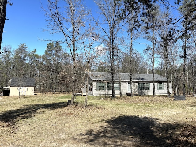 view of front of house with a storage shed, crawl space, and an outdoor structure