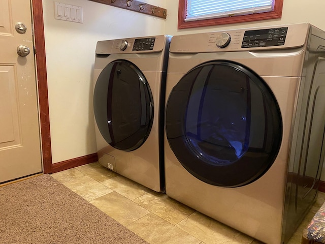 3047 Timberlane Trl, Grayling, MI 49738 - washroom with laundry area, baseboards, separate washer and dryer, and stone finish floor