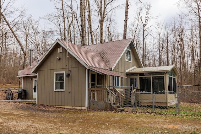 exterior space featuring a sunroom and metal roof