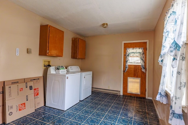 clothes washing area featuring separate washer and dryer, cabinet space, and a baseboard heating unit