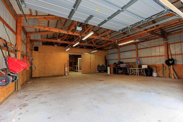 garage featuring a garage door opener and metal wall