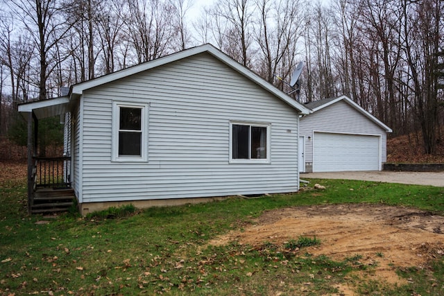 view of side of home with a lawn, a garage, and concrete driveway