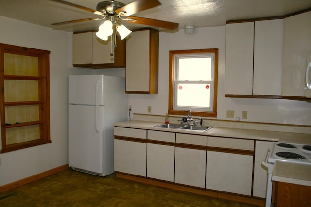 kitchen with white appliances, ceiling fan, a sink, and light countertops