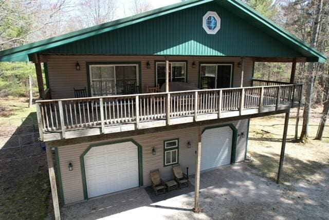 rustic home featuring driveway and a garage