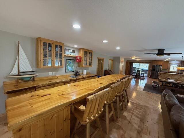 bar with recessed lighting, a ceiling fan, and light wood-type flooring