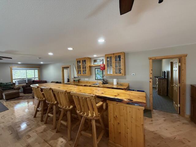 8670 N Everett Rd, Roscommon, MI 48653 - bar with a ceiling fan, indoor bar, and recessed lighting