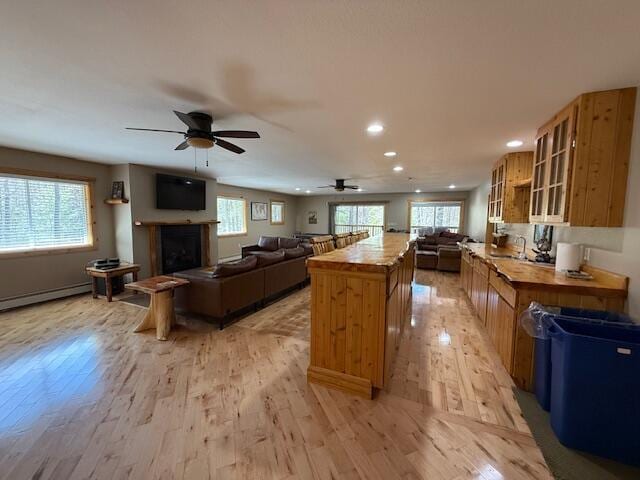 kitchen featuring plenty of natural light, a ceiling fan, recessed lighting, and open floor plan