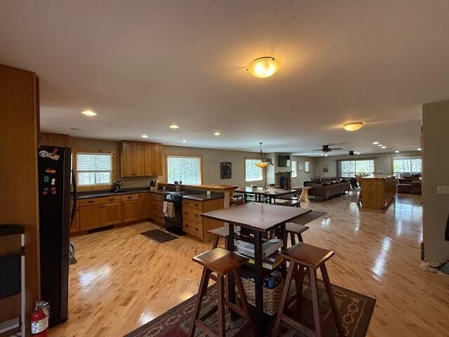 dining area featuring recessed lighting, light wood finished floors, and ceiling fan