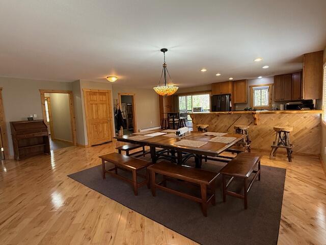 dining area featuring recessed lighting and light wood-style flooring