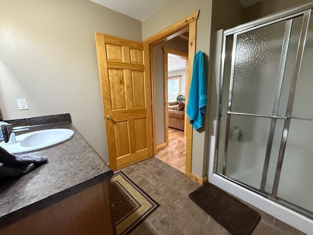 bathroom with vanity and a shower stall