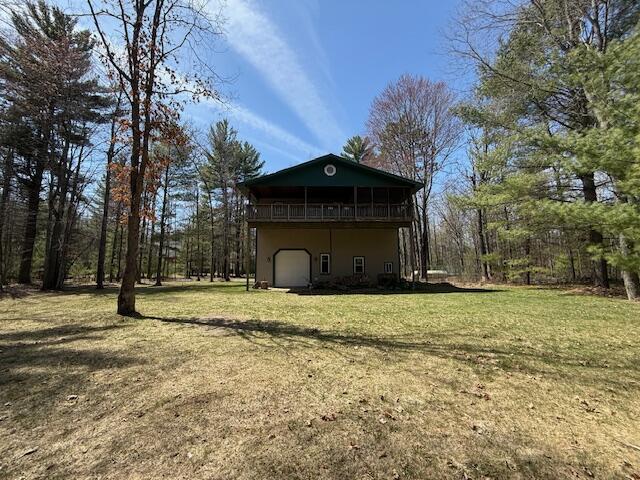 8670 N Everett Rd, Roscommon, MI 48653 - view of property exterior with a lawn