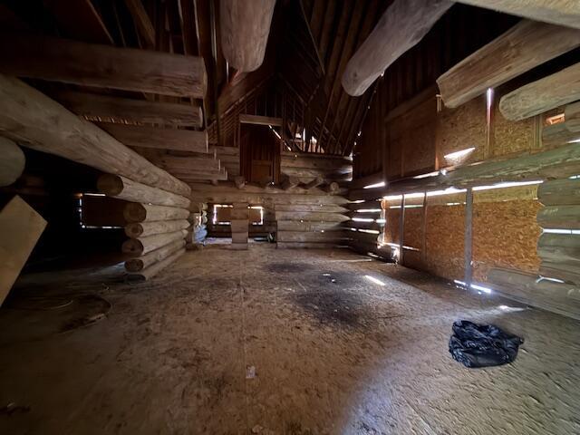 interior space with a high ceiling and rustic walls