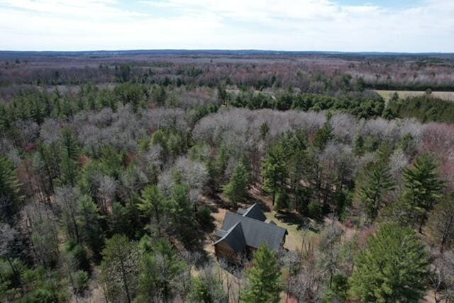 birds eye view of property featuring a wooded view