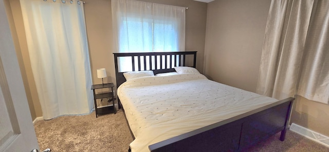 bedroom with baseboards and carpet
