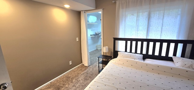 carpeted bedroom with baseboards
