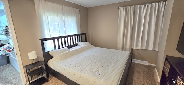 bedroom with carpet floors, multiple windows, baseboards, and visible vents