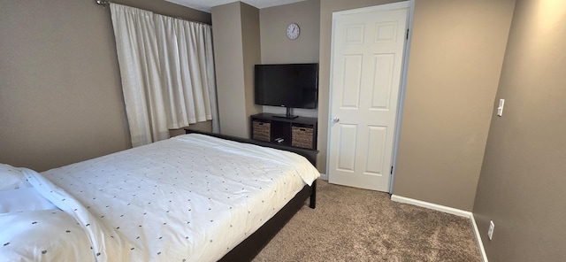 bedroom with baseboards and carpet