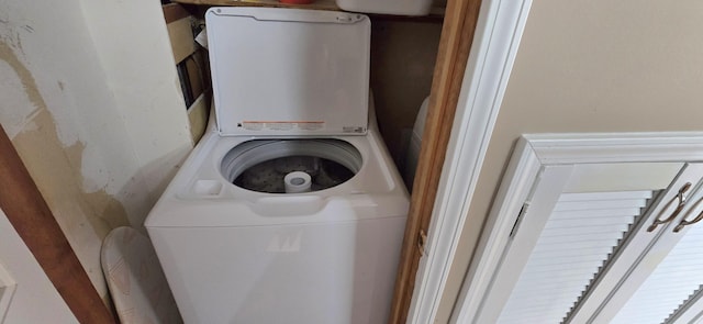 clothes washing area featuring laundry area and stacked washer / dryer