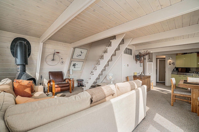 2047 W Martin Lake Rd, Gaylord, MI 49735 - carpeted living area featuring wood ceiling, visible vents, beam ceiling, wooden walls, and stairs