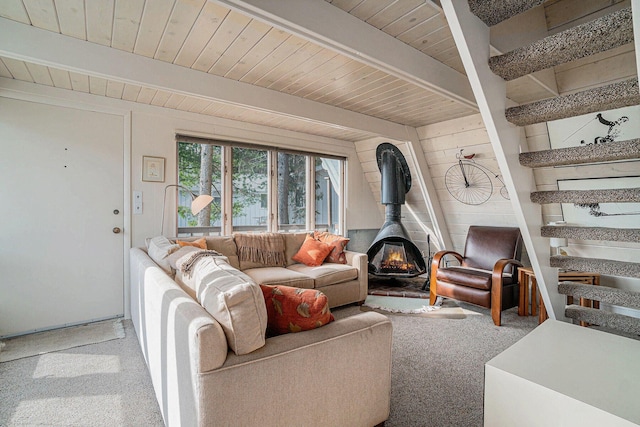 2047 W Martin Lake Rd, Gaylord, MI 49735 - carpeted living area with a wood stove, beam ceiling, and wooden ceiling
