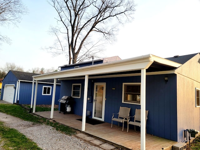 rear view of house with a porch and an outbuilding
