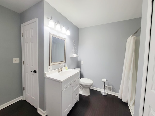 full bath featuring vanity, toilet, baseboards, wood finished floors, and visible vents