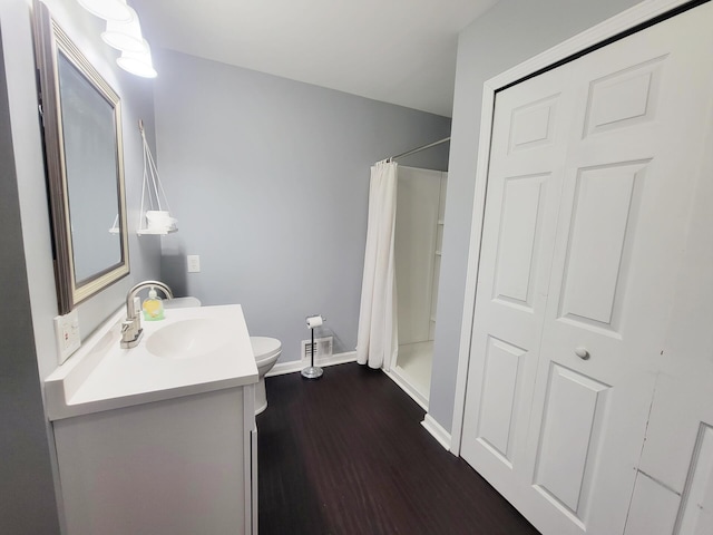 bathroom featuring vanity, visible vents, wood finished floors, toilet, and baseboards