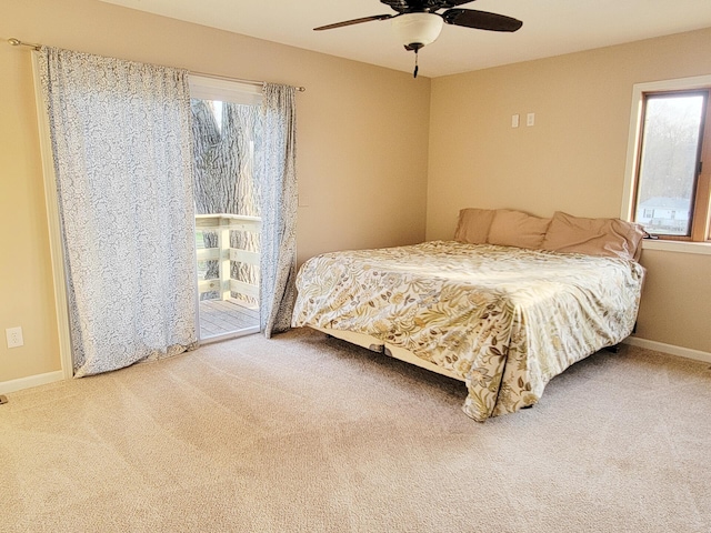 carpeted bedroom featuring baseboards, a ceiling fan, and multiple windows