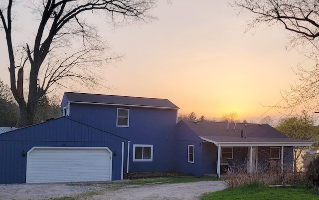 view of front of house featuring a garage and gravel driveway